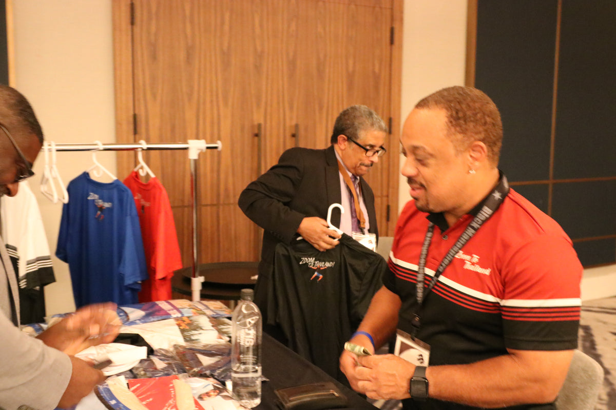 Black Manosphere Conclave attendees having a focused conversation between sessions