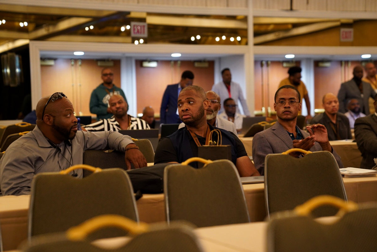 Black Manosphere Conclave attendees in conversation before a session